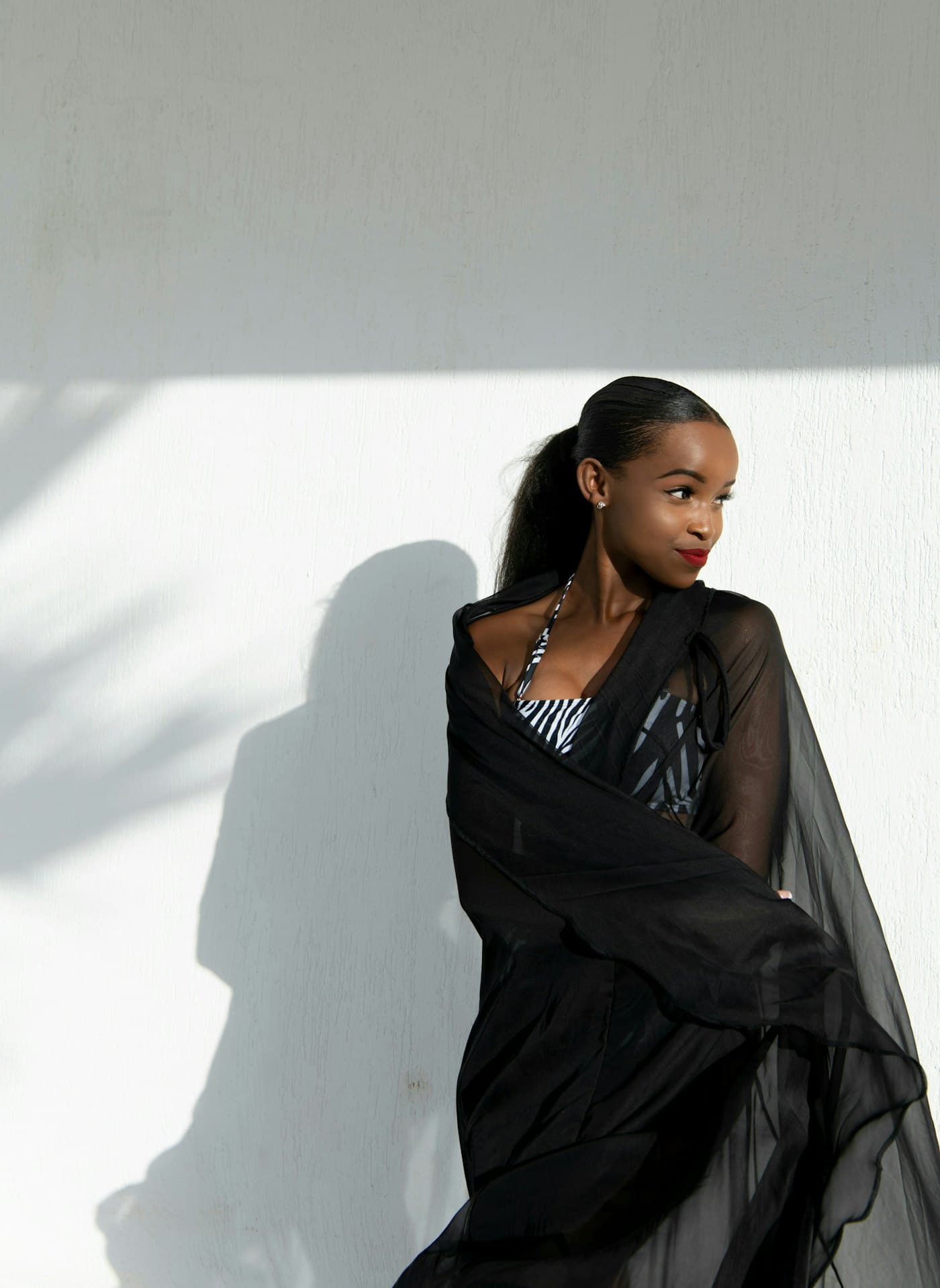 Portrait of a woman against a plain wall