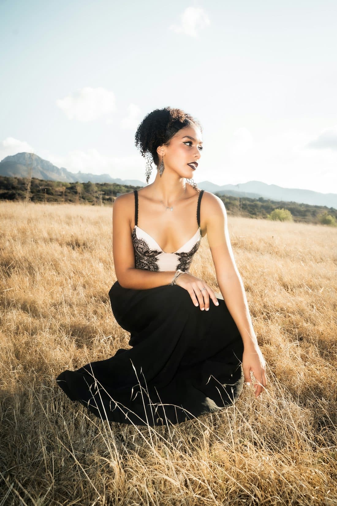 Founder portrait, formal wear, seated in dry grass
