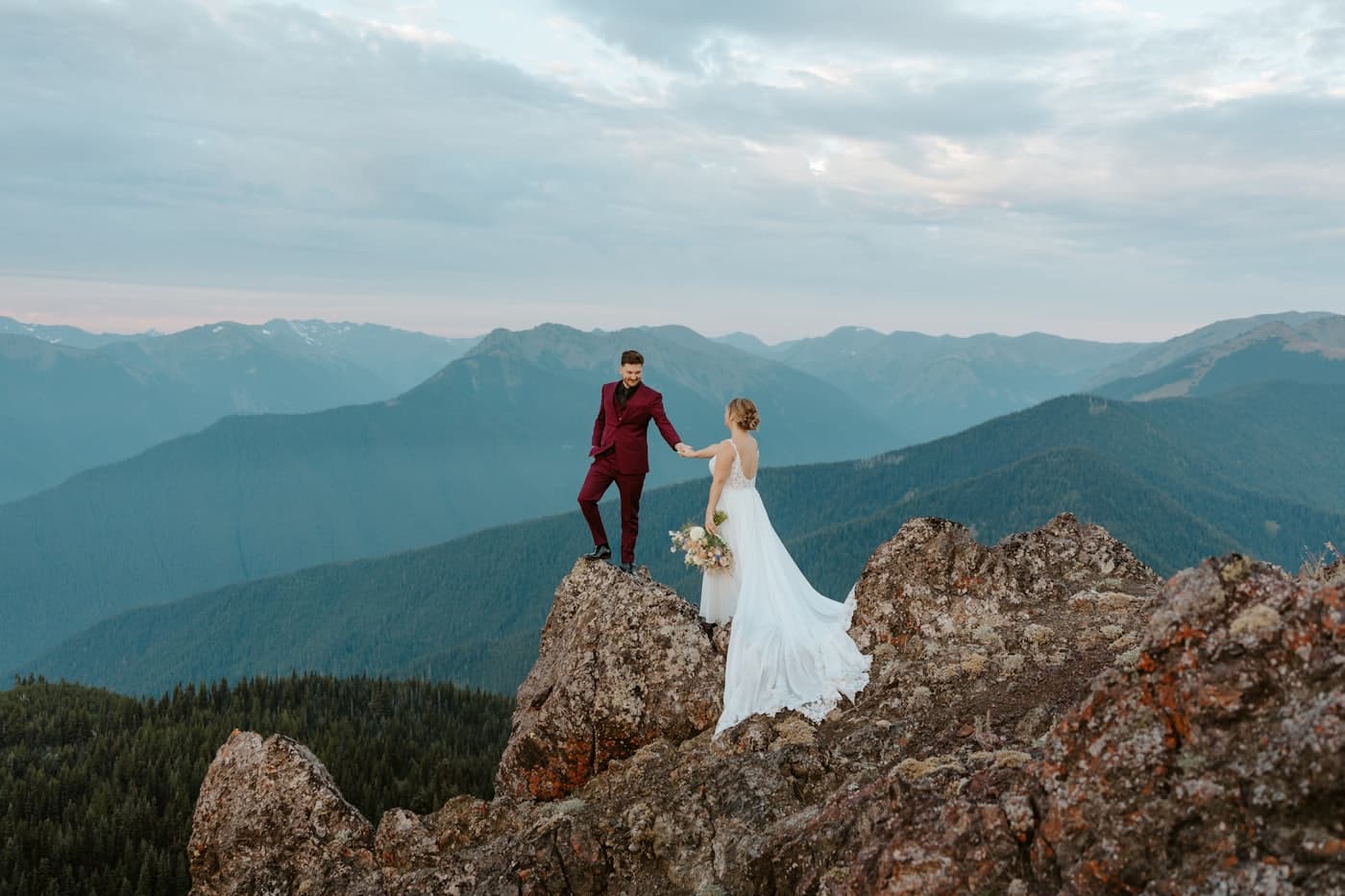 Couple on a mountain peak at sunset