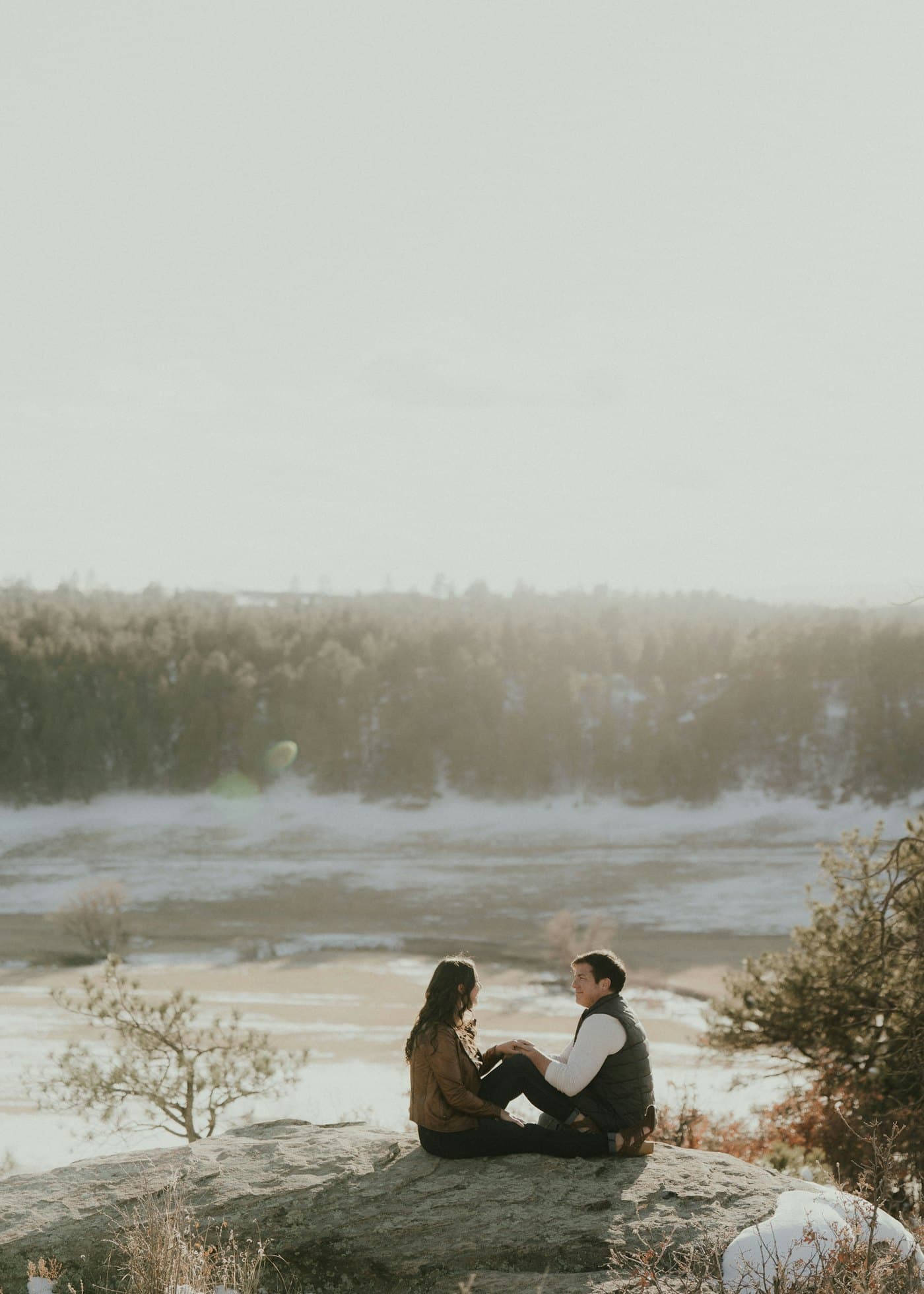 Couple seated on a rock outcrop