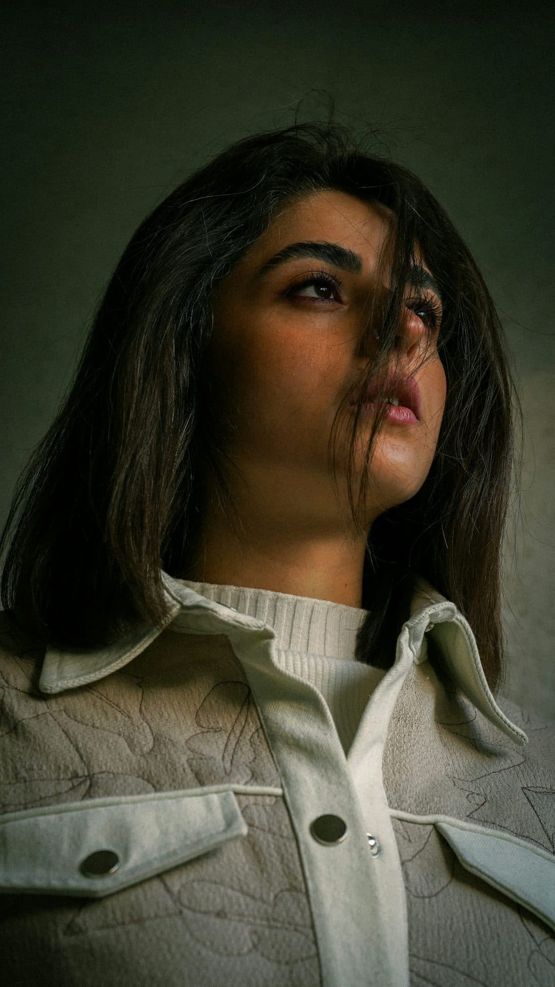 Portrait of a woman with hair caught in the wind