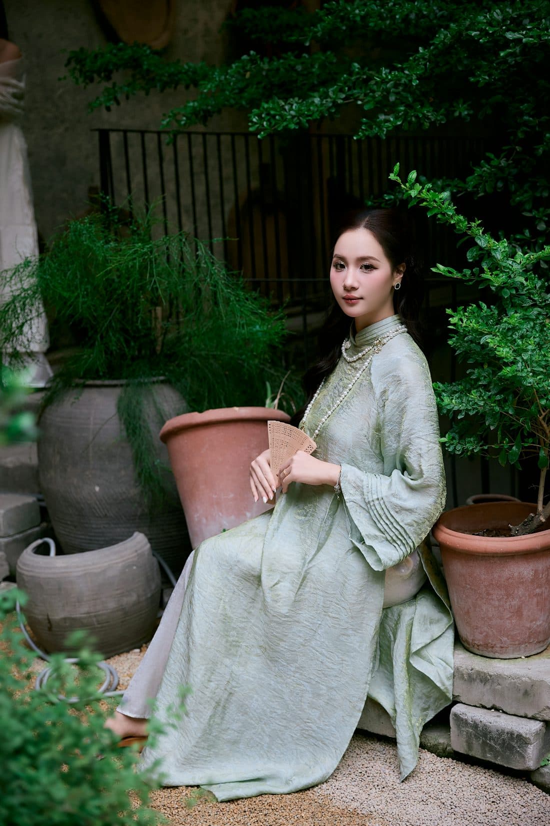 Portrait of a woman seated among plants