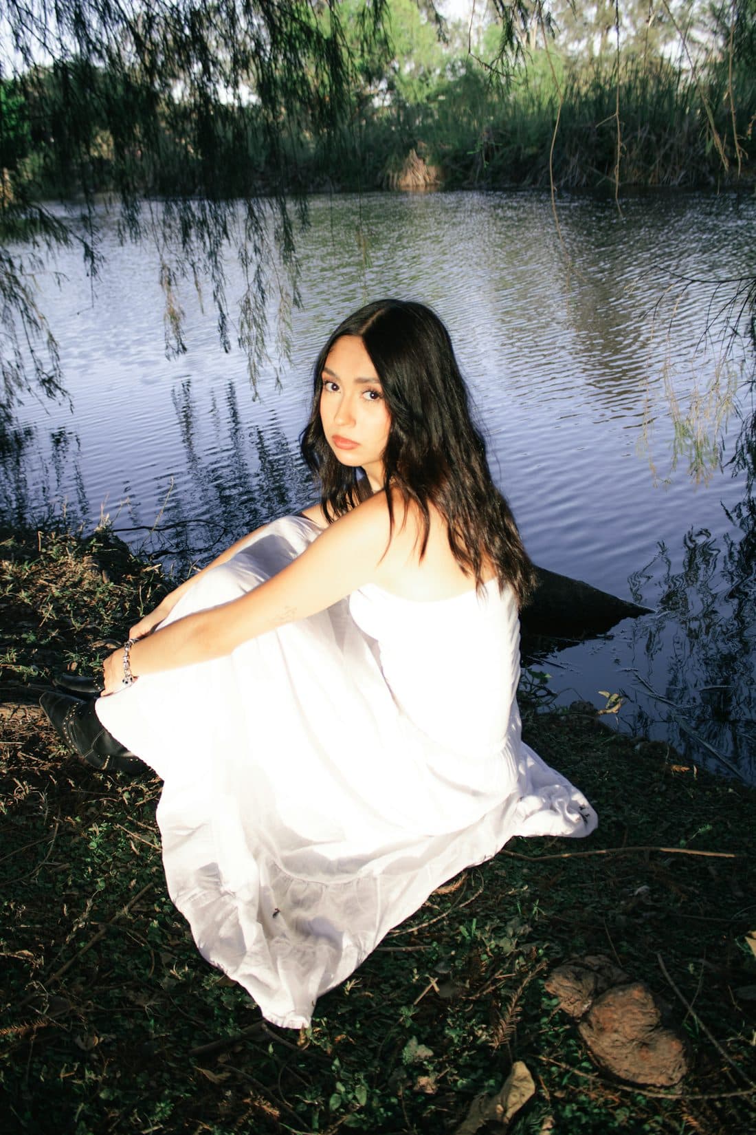 Portrait of a woman seated near calm water