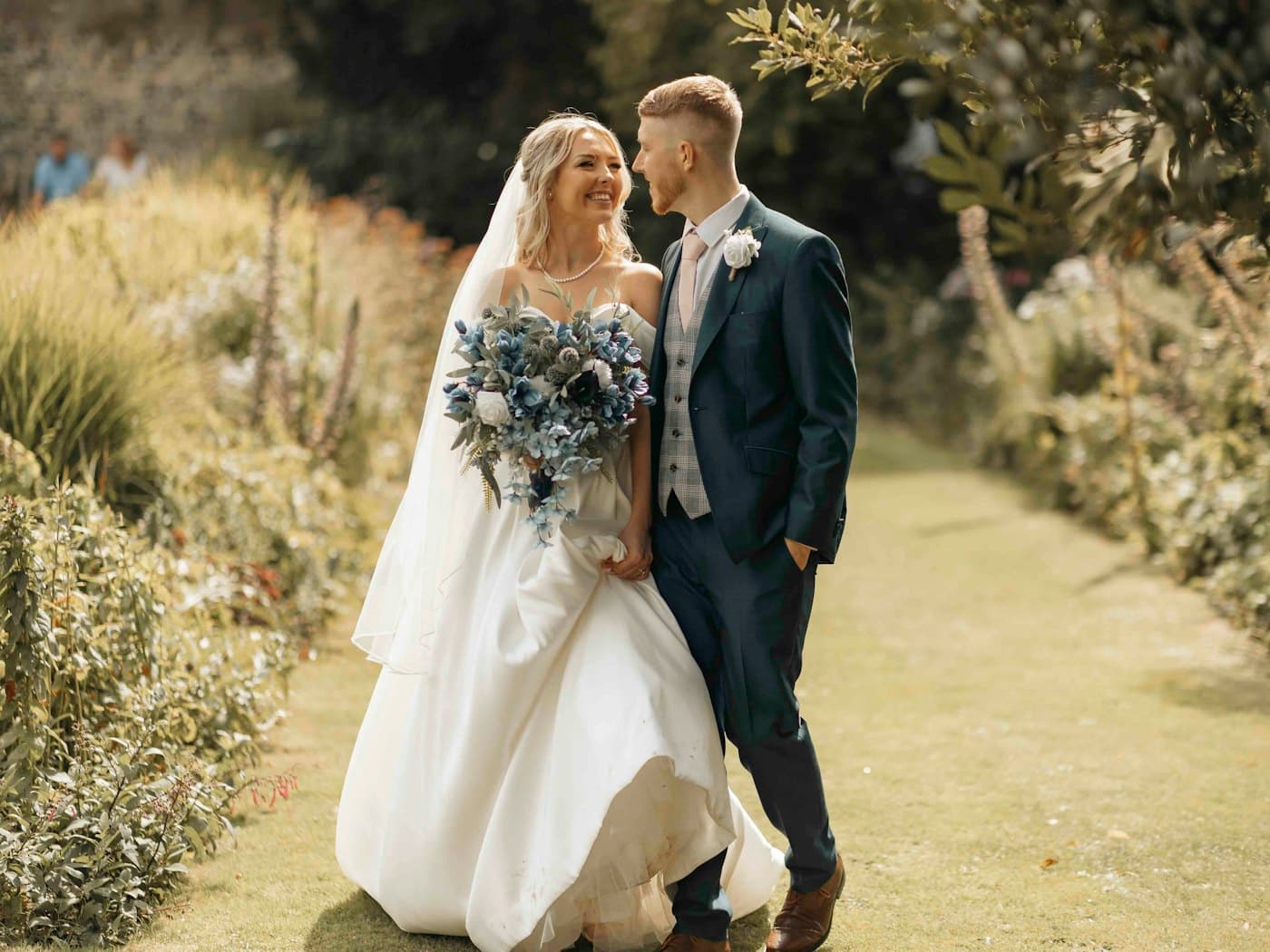 Bride and groom standing in a garden
