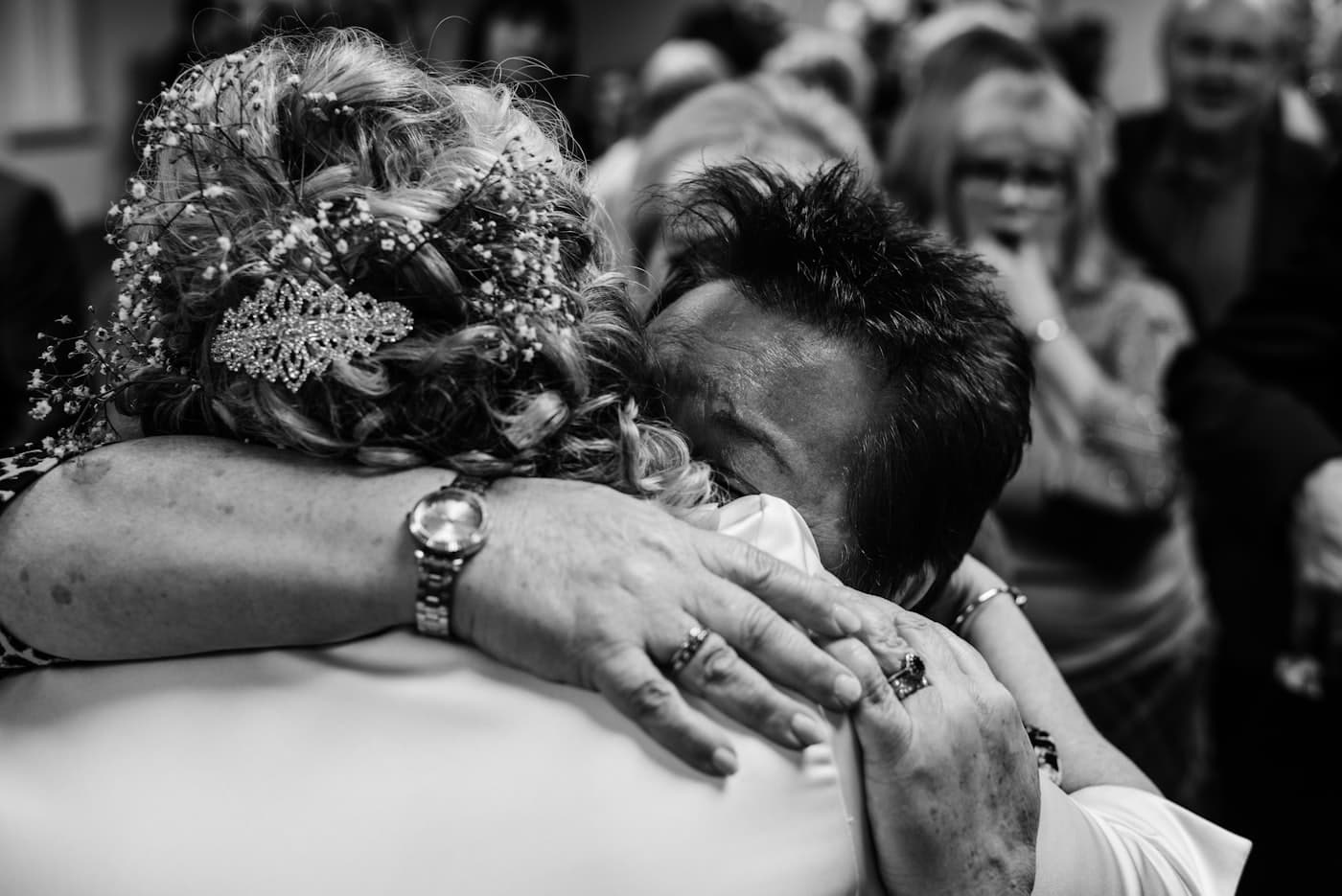 Grayscale photo of the couple holding hands